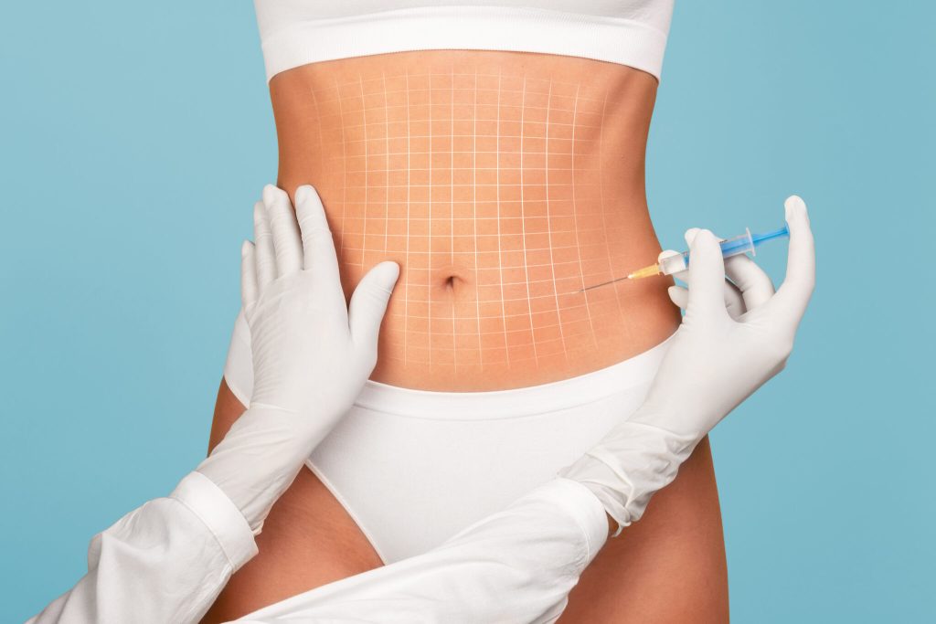 Aesthetic nurse injects fat dissolver into a woman's abdomen.