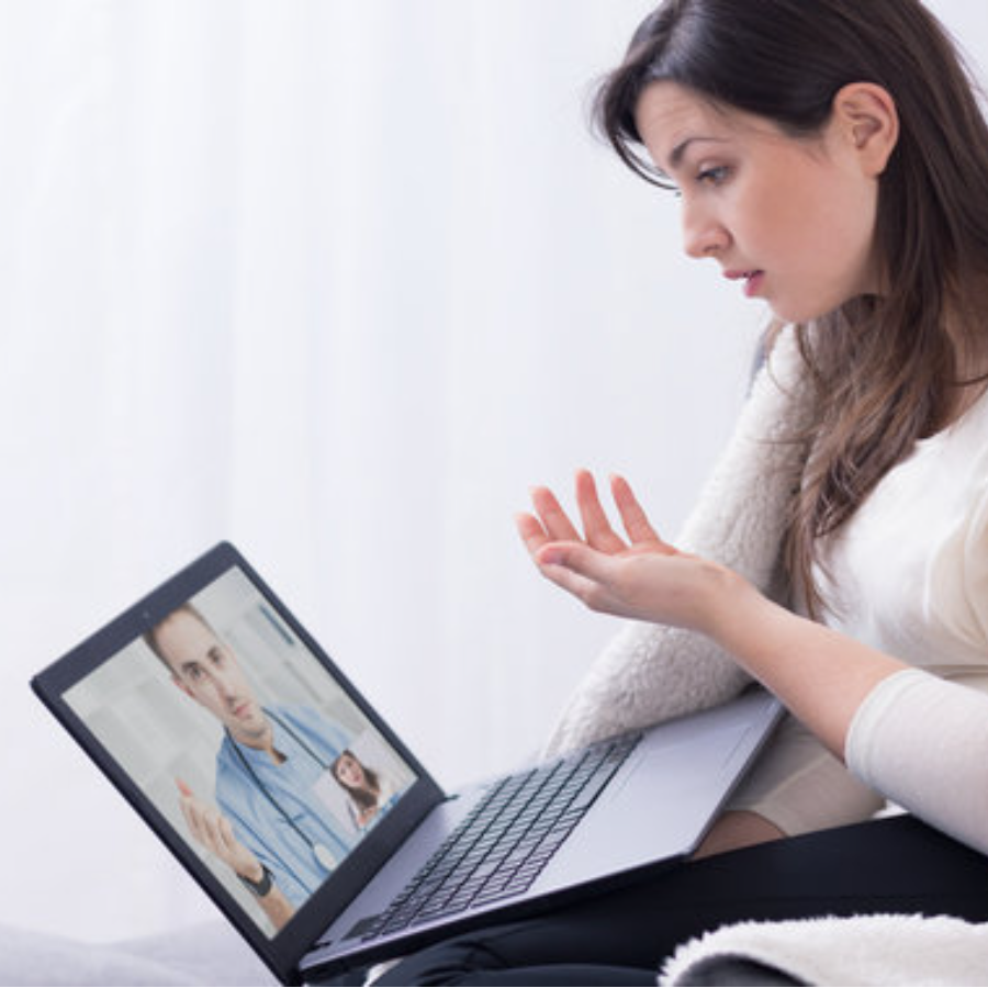 Aesthetic nurse consults with client online.