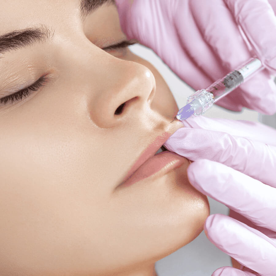 Aesthetic nurse injects their client's upper lip.