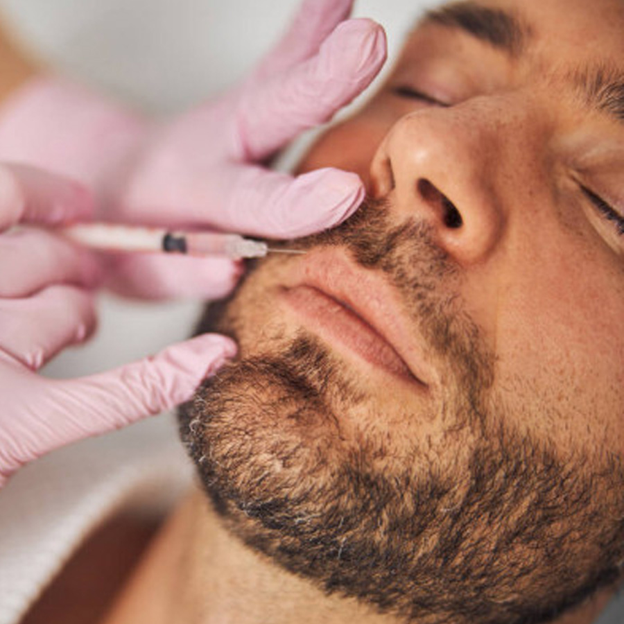 Aesthetic nurse injects their client's upper lip.