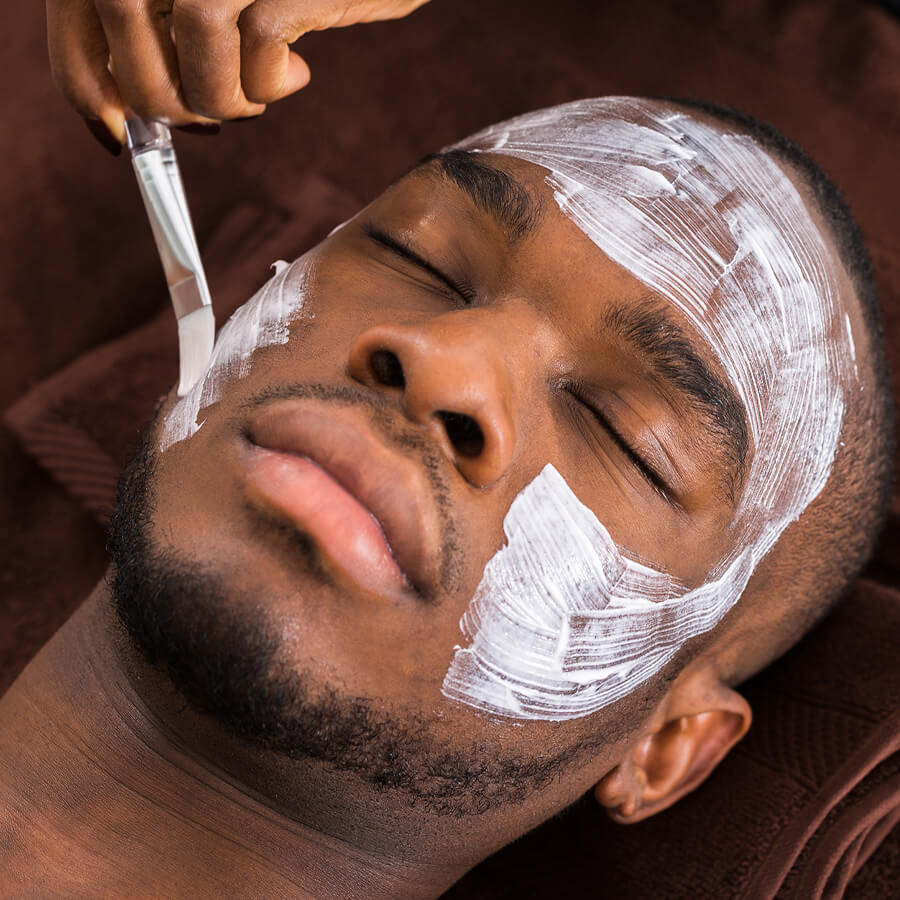 Aesthetician provides a chemical facial peel for their client.