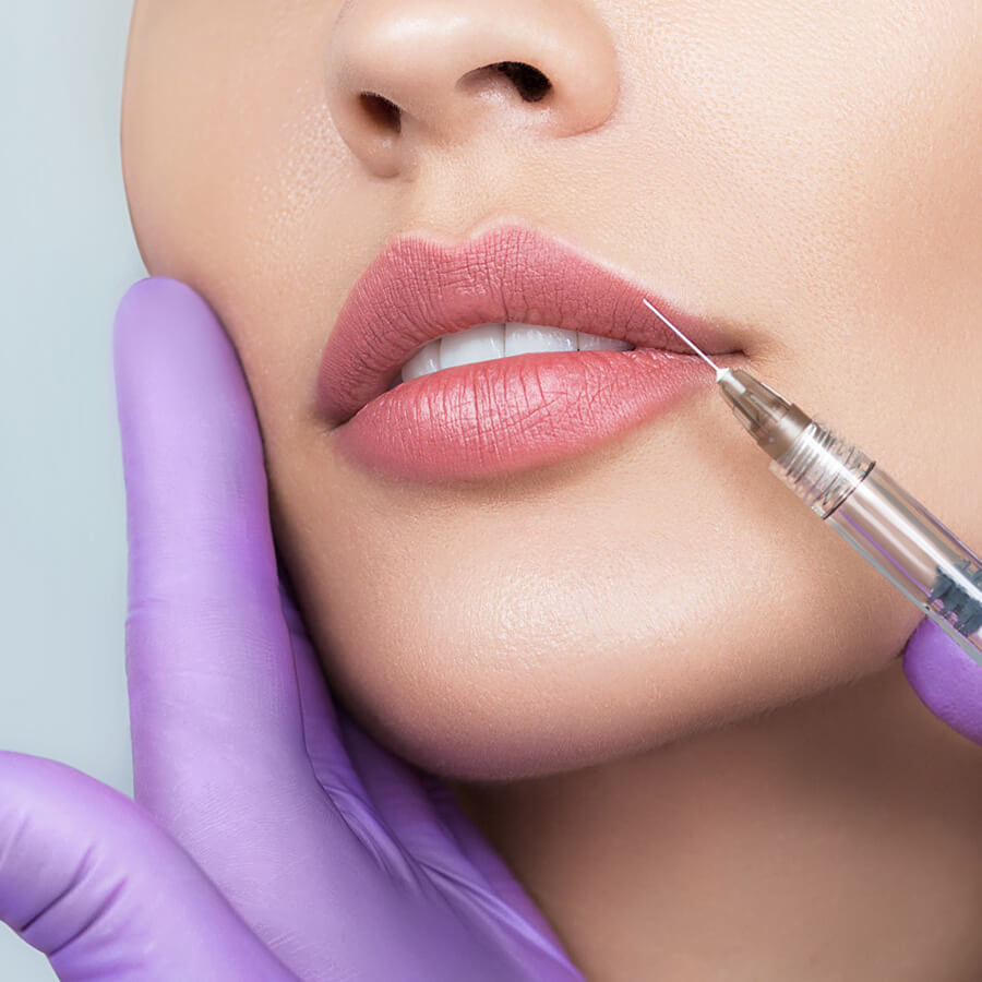 Aesthetic nurse injects their client's upper lip.